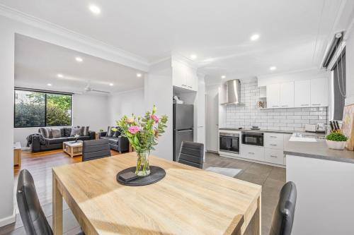 a kitchen and living room with a wooden table at Mr Webster in Ballarat