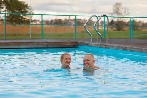 two people swimming in a swimming pool at Fra Mare Thalasso Spa in Haapsalu