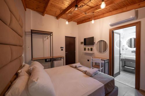 a bedroom with a large bed and a bathroom at Vila Shpetimi in Ksamil