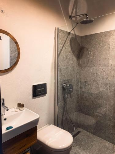 a bathroom with a shower and a toilet and a sink at Casa Alegre Alaçatı in Alacati