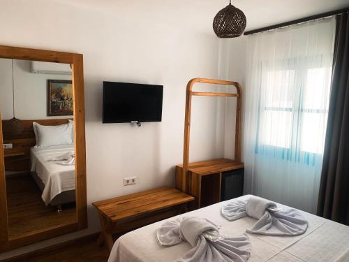 a hotel room with a bed and a mirror at Casa Alegre Alaçatı in Alacati