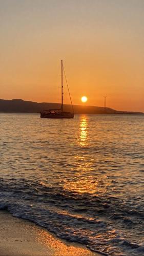 a boat sitting on the water at sunset at Stella Marina in Scilla