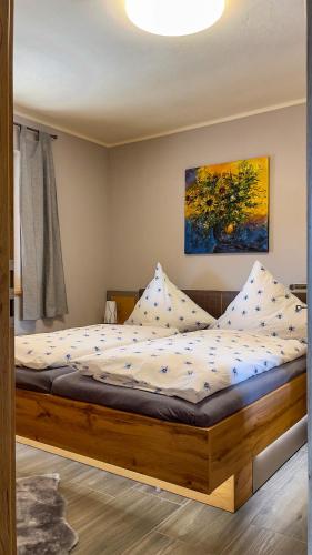 a bedroom with a bed with a wooden frame at Ferienwohnung Olbernhau 7 Täler - Apartment in Olbernhau