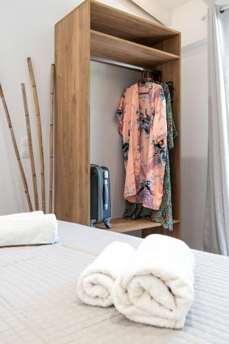 a bedroom with a bed with towels on it at Christiana's Cottage in Sidari