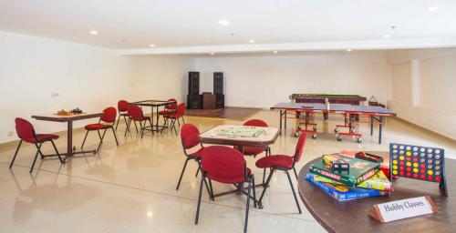 a room with tables and chairs and a ping pong table at Sterling Munnar in Munnar