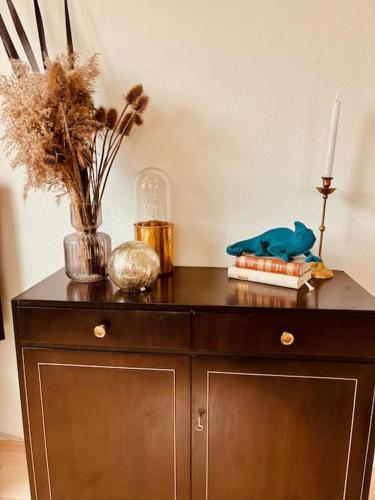 a wooden cabinet with a candle on top of it at Atelier Farbenreich No 8 in Eching