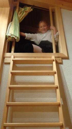 a woman is sitting in a bunk bed at Haus Patricia in Kartitsch