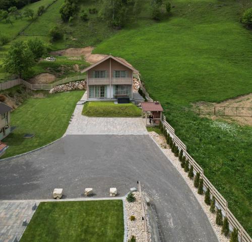 an aerial view of a house on a hill at Eny Guesthouse in Moieciu de Jos