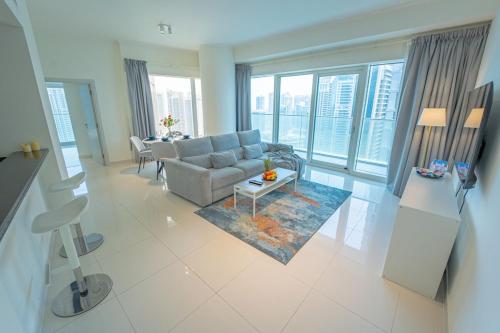 a living room with a couch and a table at AWS Homes - Unique High View at Damac Heights in Dubai