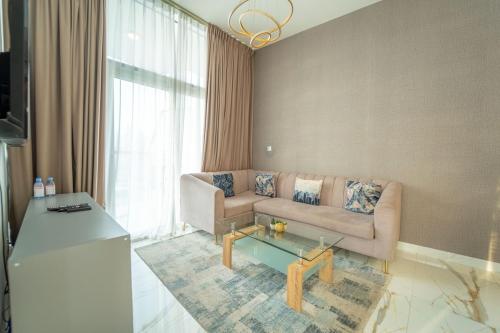 a living room with a couch and a coffee table at AWS Holiday Homes - Luxurious 2BR in Business Bay in Dubai