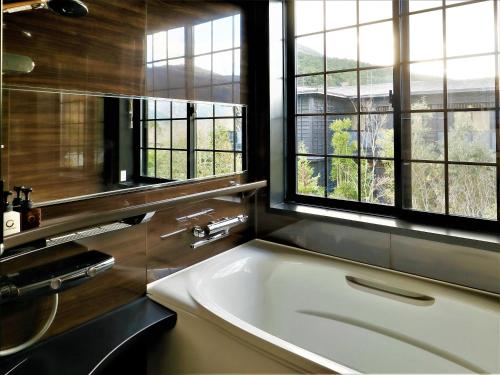 a bathroom with a large white sink and windows at Hotel Morinokaze Hakone Sengokuhara in Hakone