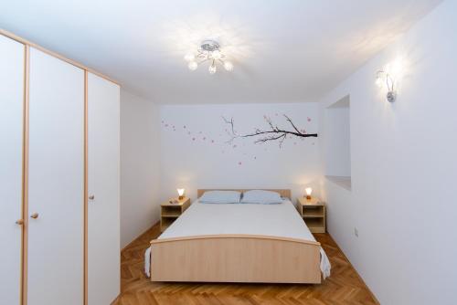 a bedroom with a bed and two side tables at Apartment Ema in Dubrovnik