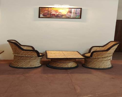 two chairs and a wooden table and a table and two chairs at The Vanashv in Tehla
