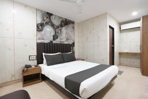 a bedroom with a large bed in a room at Hotel U Life Residency Mumbai in Mumbai