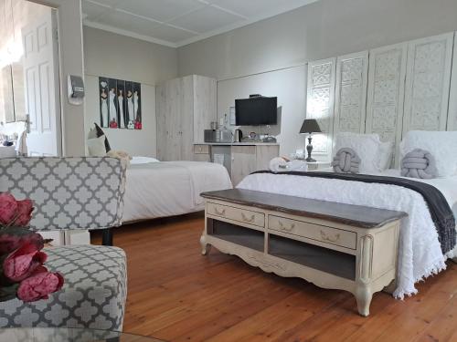 a large bedroom with two beds and a couch at De Witte Huis in Bethlehem