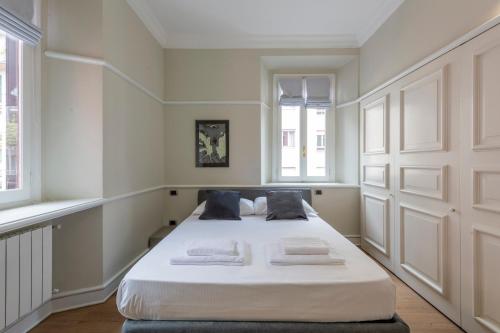 a bedroom with a large white bed with two pillows at Milan Royal Suites - Centro in Milan