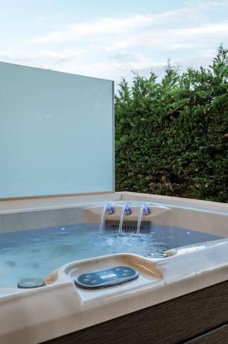 a bath tub with a water fountain in it at Luxe Seaside Anavissos- Athens, 3 Bedroom,Jacuzzi in Anavissos