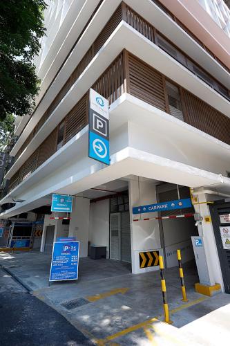 a building with a parking sign in front of it at Hotel Transit Kuala Lumpur in Kuala Lumpur