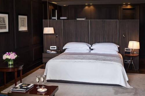 a bedroom with a large bed with a wooden headboard at The David Citadel Jerusalem in Jerusalem