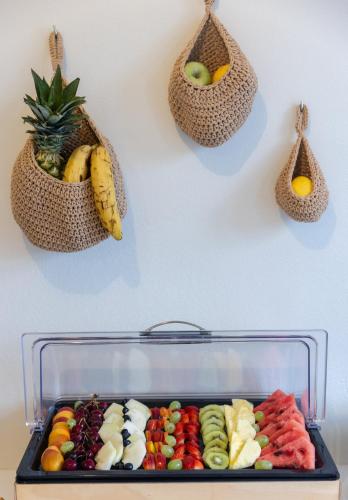 a display of fruit in bags on a wall at Scorpios Beach in Monolithos