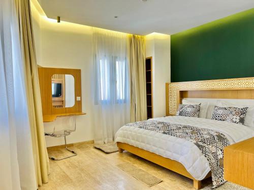 a bedroom with a bed and a green wall at Soho Boutique Tetuán in Tetouan