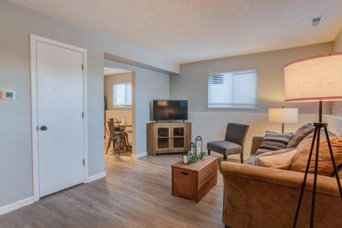 a living room with a couch and a tv at Romantic Getaway Base of Mountains Parks & Trails in Colorado Springs