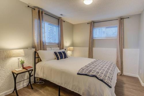 a bedroom with a bed and two windows at Romantic Getaway Base of Mountains Parks & Trails in Colorado Springs