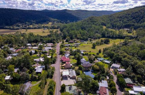 an aerial view of a small village in the mountains at The Rustic Nest Yarramalong in Yarramalong
