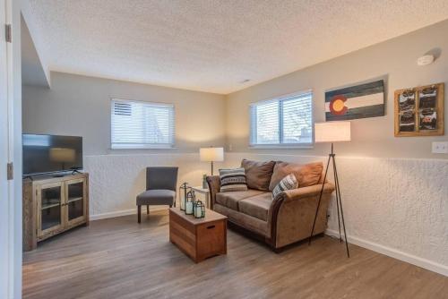a living room with a couch and a tv at Romantic Getaway Base of Mountains Parks & Trails in Colorado Springs