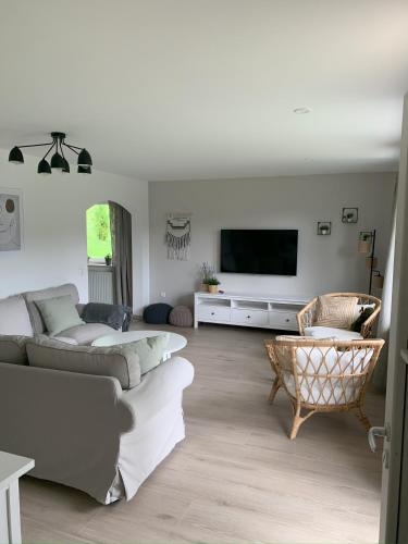 a living room with two couches and a flat screen tv at FerienChata Bärenriegel in Arrach