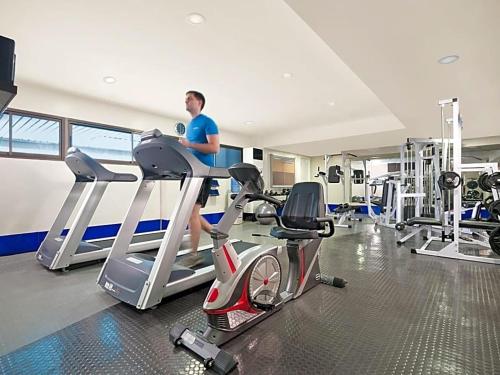 a man on a treadmill in a gym at Olympia Makati Studio former Somerset Olympia Makati in Manila