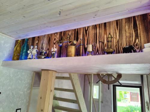 a shelf with various items on it in a room at Tedre majutus in Kärdla