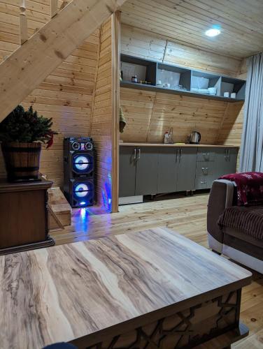 a kitchen and living room with a table in a room at Prime House Cottages in Keda