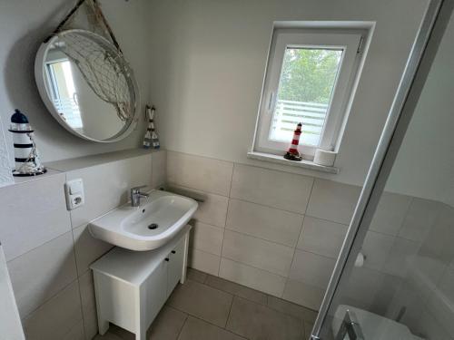 a bathroom with a sink and a mirror at Tamaris Resort in Graal-Müritz
