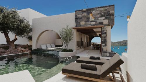 a villa with a swimming pool and a resort at Elounda Stories Boutique Hotel in Elounda