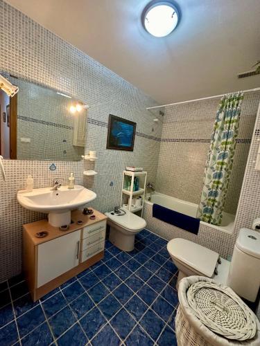 a bathroom with a sink and a toilet and a tub at Apt Oropesa town Rentalholidays in Oropesa del Mar