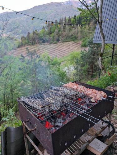 a grill with meat and other food on it at Prime House Cottages in Keda