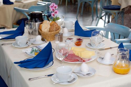 a white table with plates of food on it at Hotel Georg in Witten