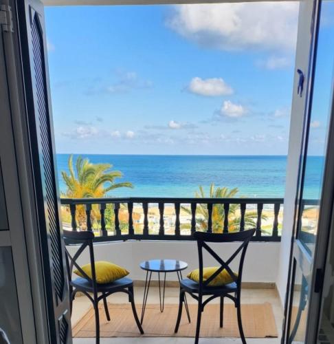a balcony with a view of the ocean at L'univers de la mer appartement in Douar el Hafey