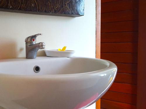 a sink in a bathroom with a faucet at Juada Garden in Seminyak