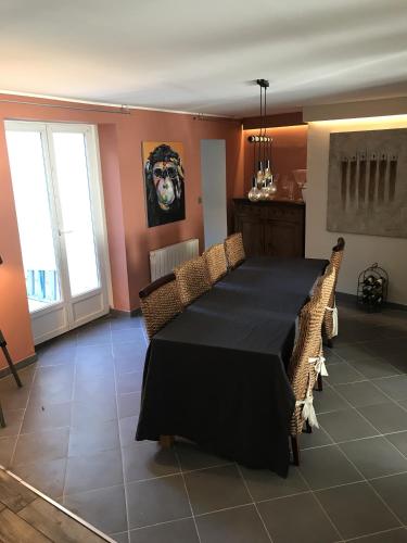 une salle à manger avec une table et des chaises noires dans l'établissement Maison familiale proche Nausicaa, à Boulogne-sur-Mer
