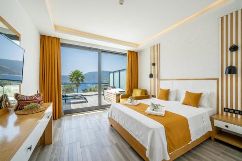a hotel room with a bed and a large window at Kalkan Beach Park Hotel in Kas