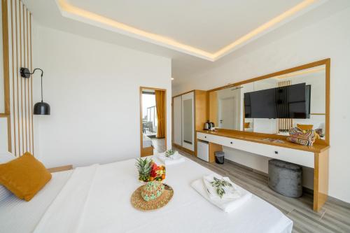 a hotel room with a large bed and a large mirror at Kalkan Beach Park Hotel in Kas