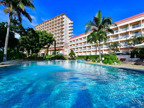 a large swimming pool in front of a hotel at Hotel Breezebay Marina in Miyako-jima