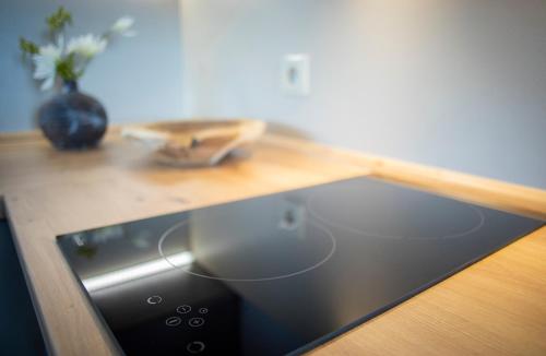 a kitchen counter with a sink and a wooden counter top at Penzion Horska Kvilda in Horská Kvilda