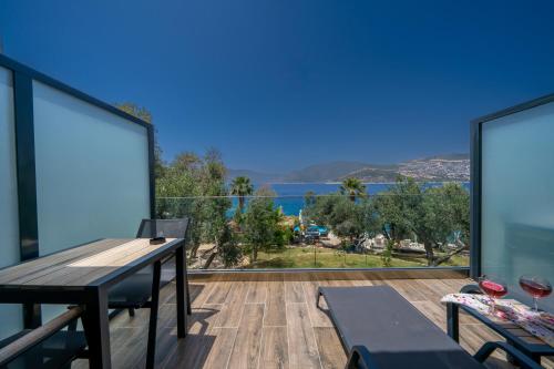 a house with a balcony with a view of the ocean at Kalkan Beach Park Hotel in Kaş