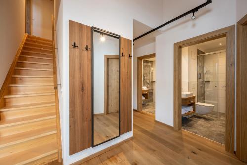 a room with a staircase and a bathroom with a toilet at Hotel Almschlössl & Schrotteralm in Obertauern