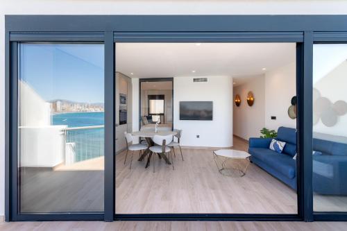 a living room with a blue couch and a table at ARENAL SUITES BENIDORM in Benidorm