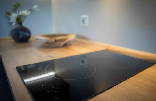 a kitchen counter with a sink and a wooden counter top at Penzion Horska Kvilda in Horská Kvilda