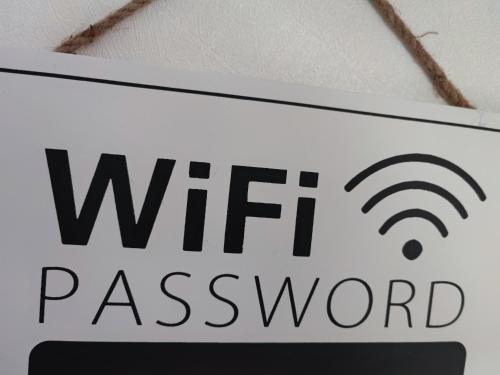 a sign that reads wifi password on a ceiling at Monts repos! in Monts
